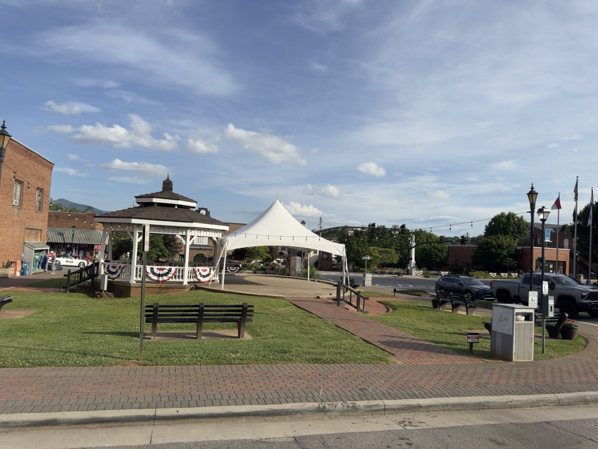 The gazebo and town square green in downtown Franklin, NC, framed by mountains